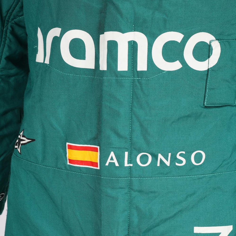Close-up of the fabric and stitching on Fernando Alonso’s 2023 F1 racing suit, capturing the high-quality material and detailed sponsor branding, designed for durability and race-ready functionality.