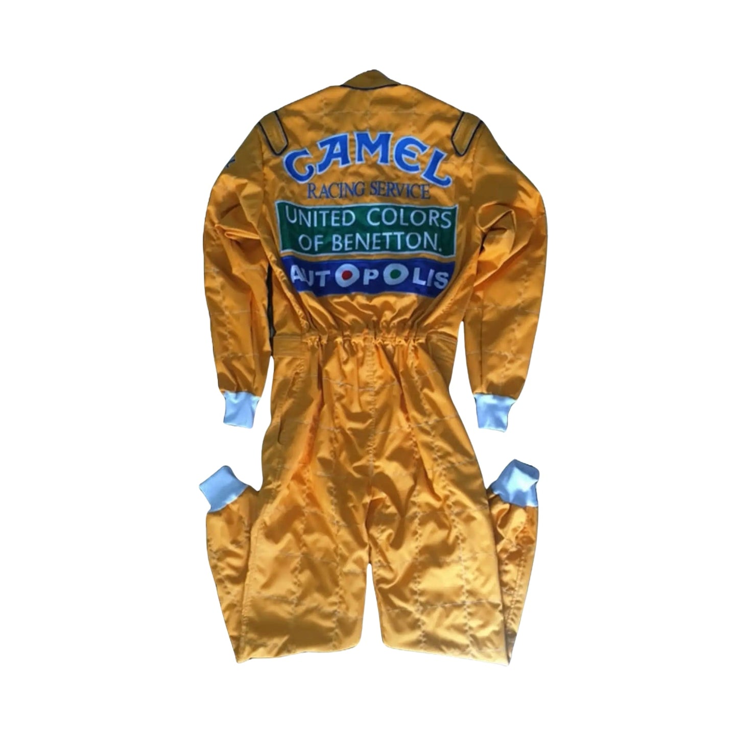 Back side of the 1992 Formula 1 suit worn by Michael Schumacher, showcasing era-specific sponsor logos and reinforced fabric seams for safety.