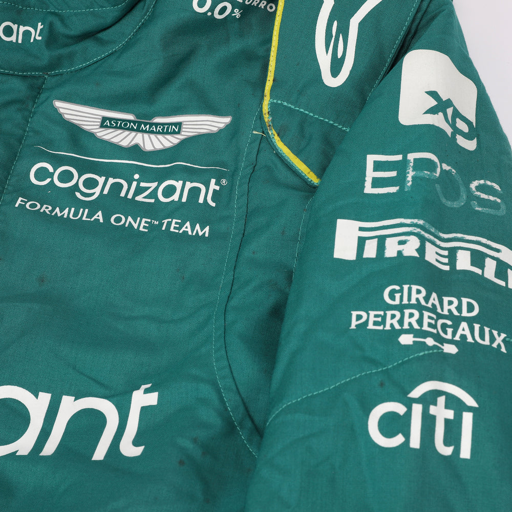 Close-up of the fabric and stitching on Fernando Alonso’s 2023 F1 racing suit, capturing the high-quality material and detailed sponsor branding, designed for durability and race-ready functionality.