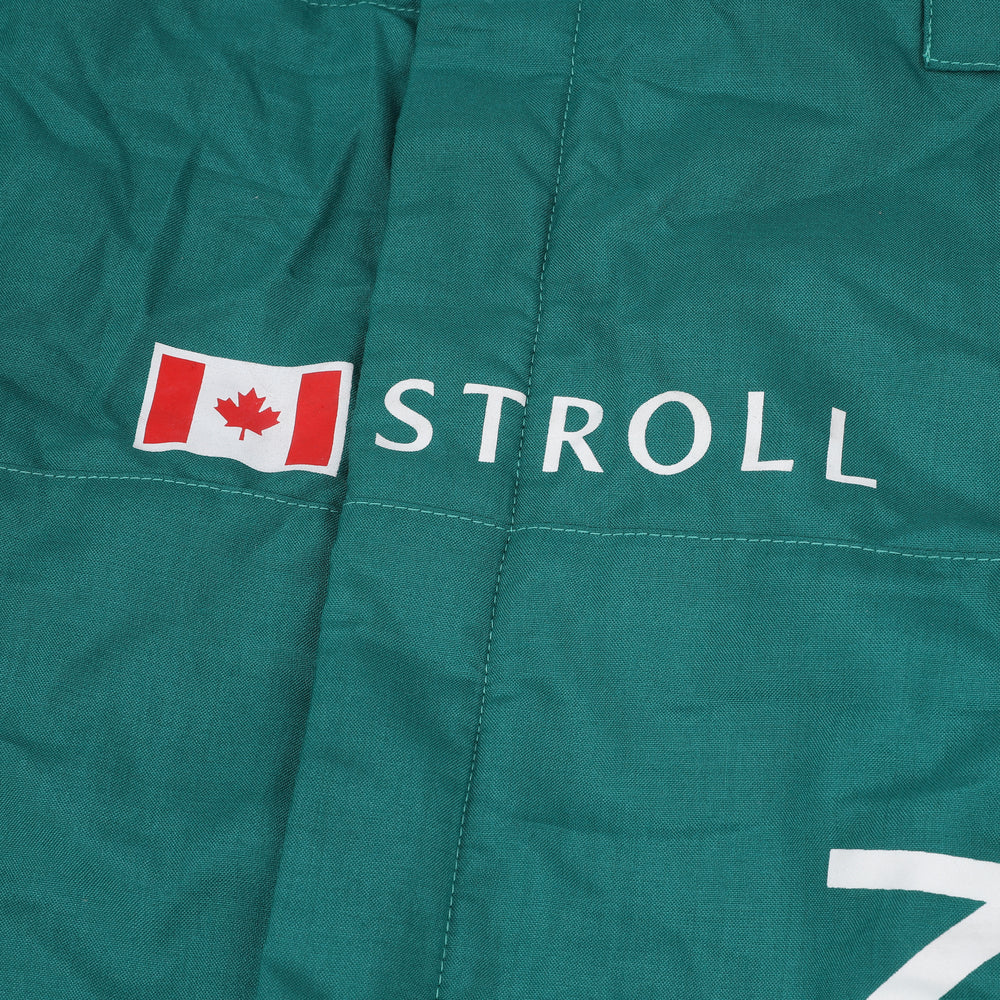 Close-up shot of Lance Stroll’s 2023 F1 racing suit fabric and stitching, focusing on the high-quality material and visible sponsor branding, emphasizing durability and race-ready functionality.