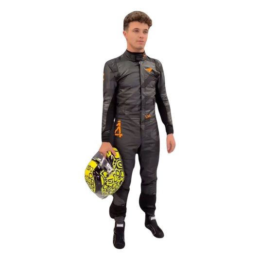 Front view of the 2025 McLaren F1 livery reveal racing costume worn by Lando Norris featuring a sleek matte black base with bold orange logos and driver initials (LN4) in neon 
