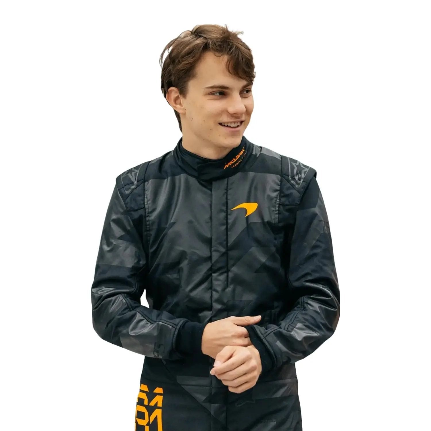 Close-up of Piastri with a —contrasting the matte black suit.